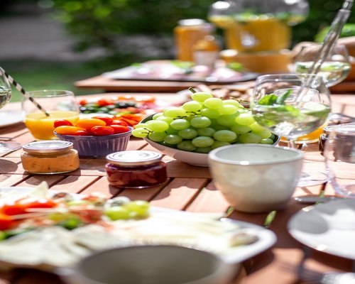 A healthy breakfast with fruits and a glass of water on a wooden table